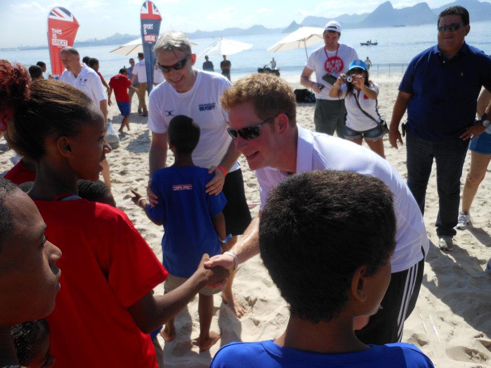 Earlier in the day Prince Harry prepares to play some beach Rugby Seven's with some children