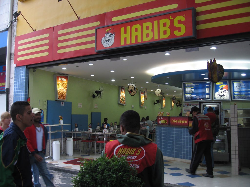 A Habib’s fast-food restaurant storefront in Brazil, with delivery staff in branded jackets