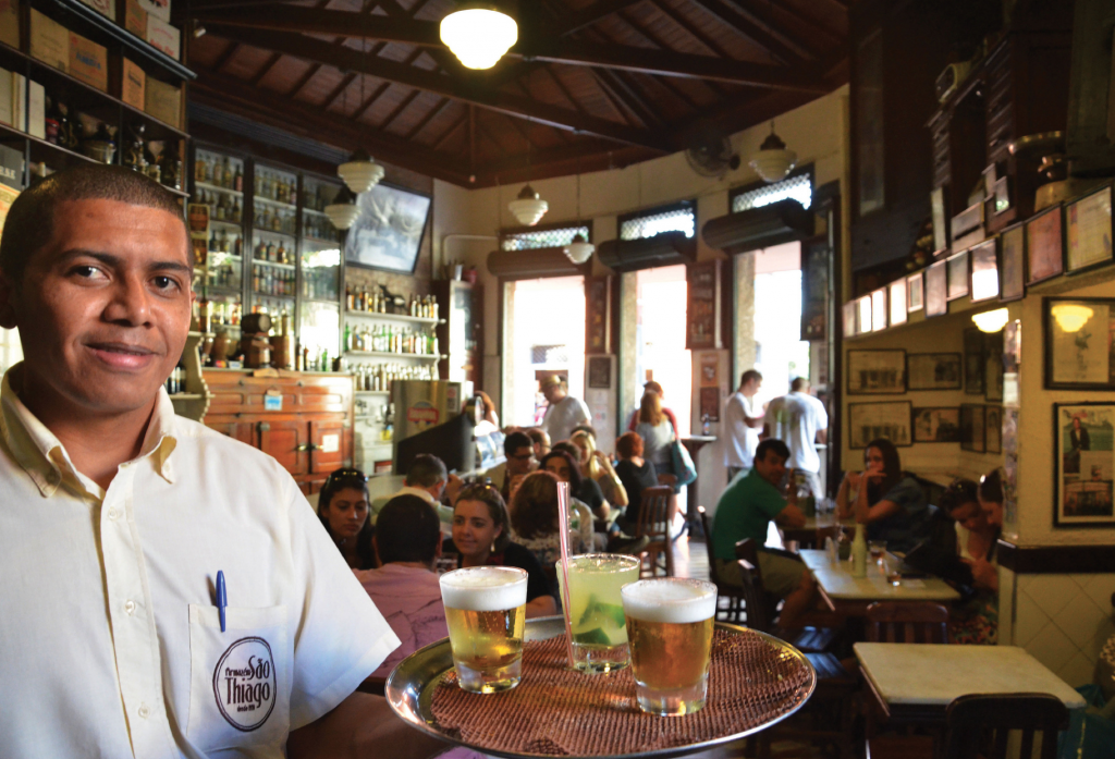 Waiter carrying beers in a classic carioca boteco
