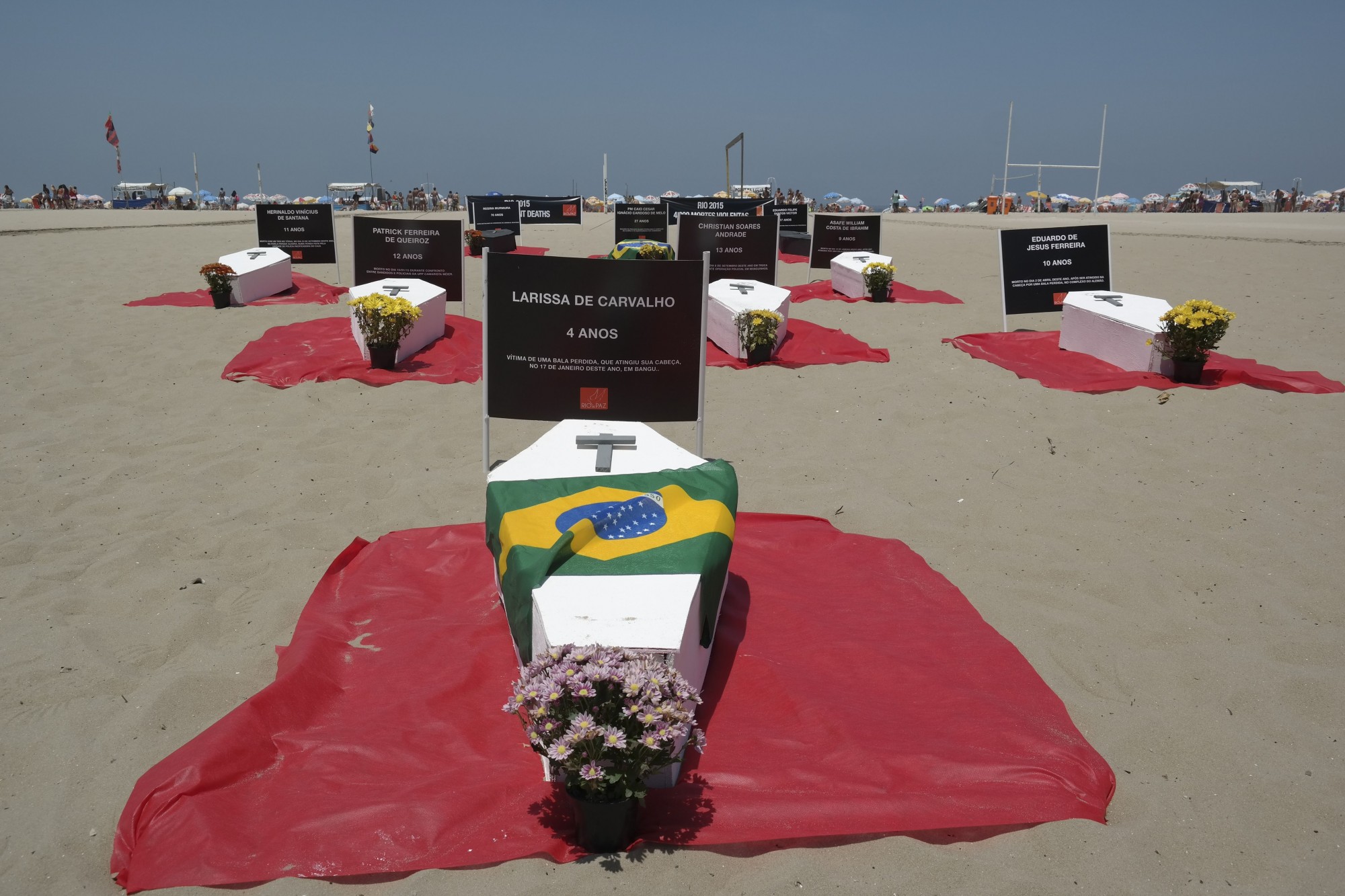 Brazil, Rio de Janeiro,Protesters place coffins to symbolize violent deaths which occurred in 2015 in Rio on Copacabana Beach