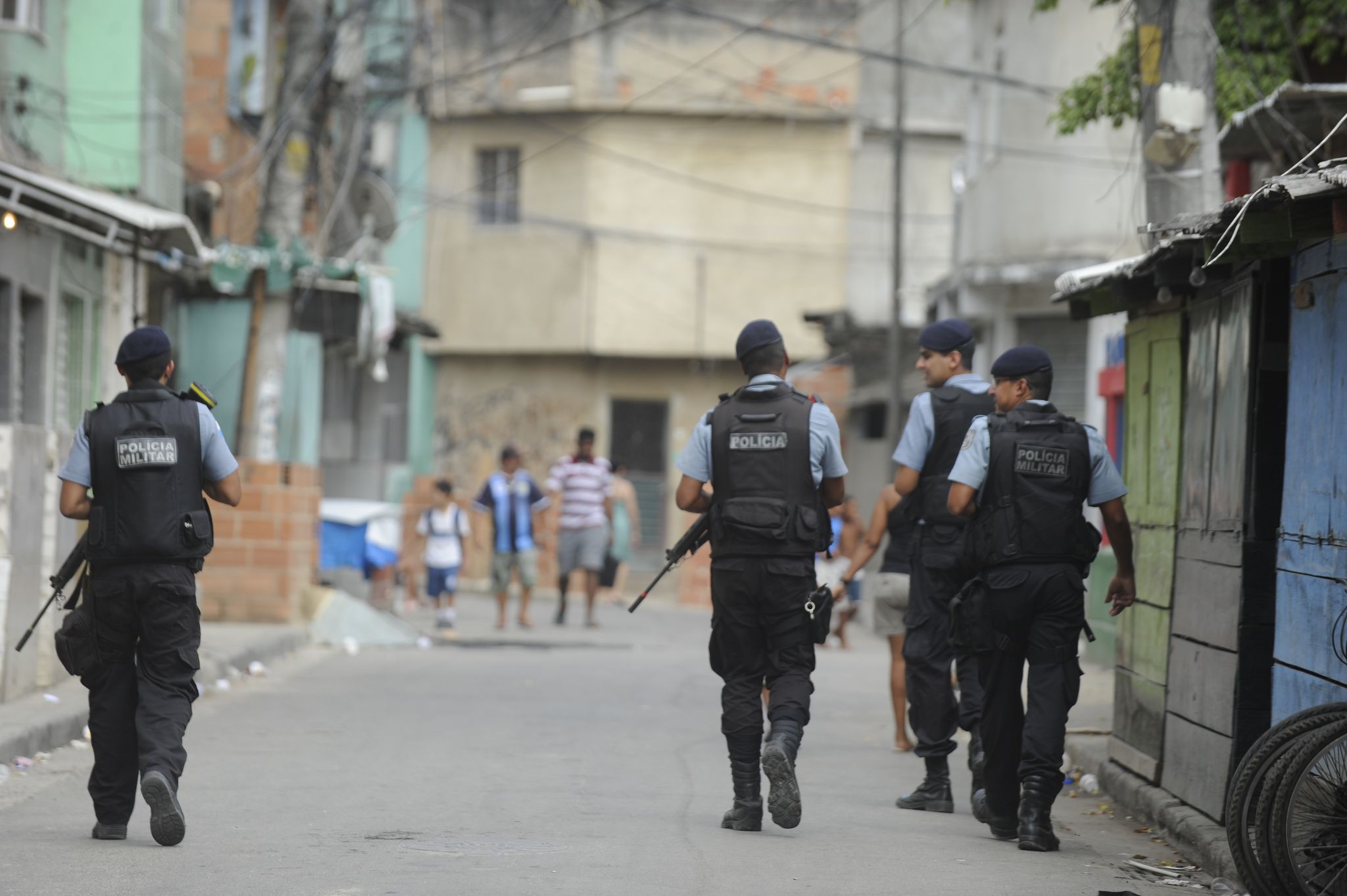 Police officers walk around the Mandela Community one of the 38 with UPPs, Rio de Janeiro, Brazil
