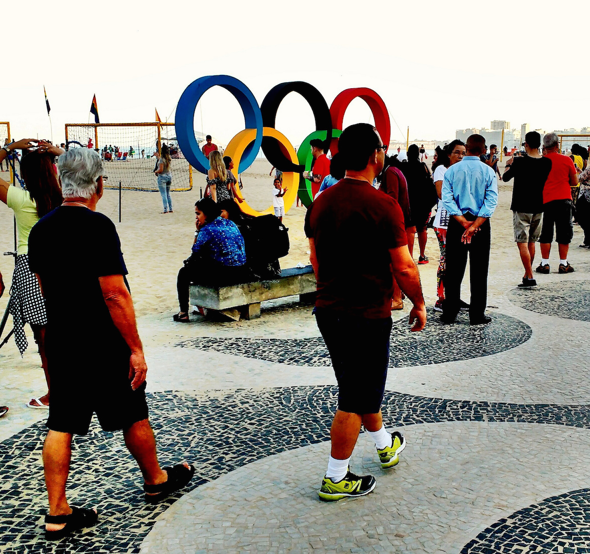 Brazil,Visitors walking on Copacabana Beach where a replica of the Olympic Rings have been placed,