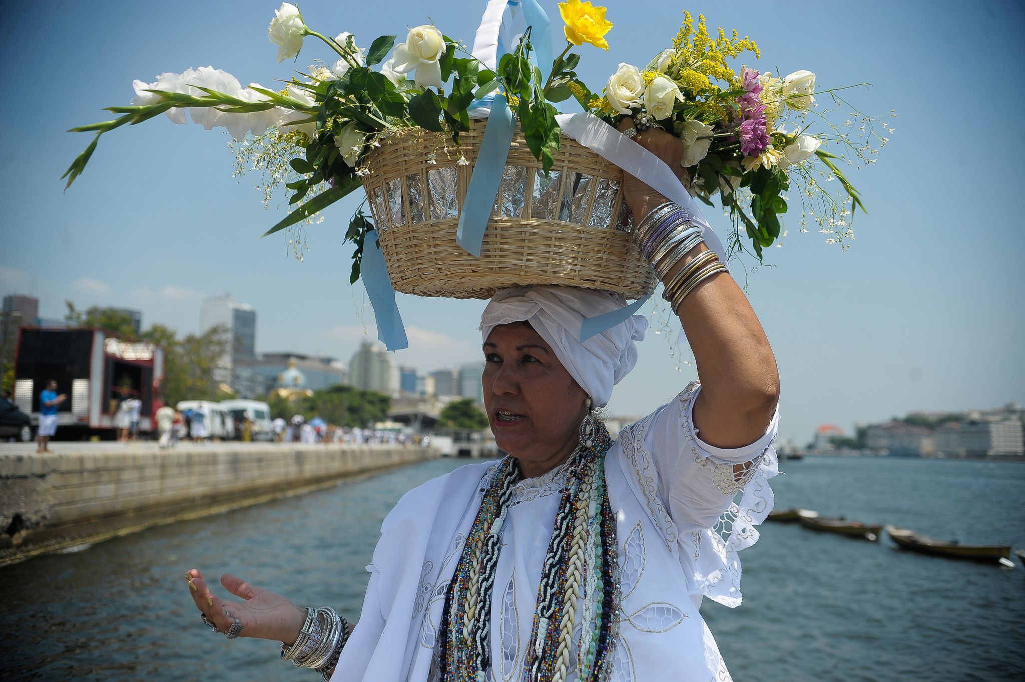 Brazil, Rio de Janeiro,Umbandista-religion members carry flowers to the sea to honor Godess of the Sea, Iemanjá,