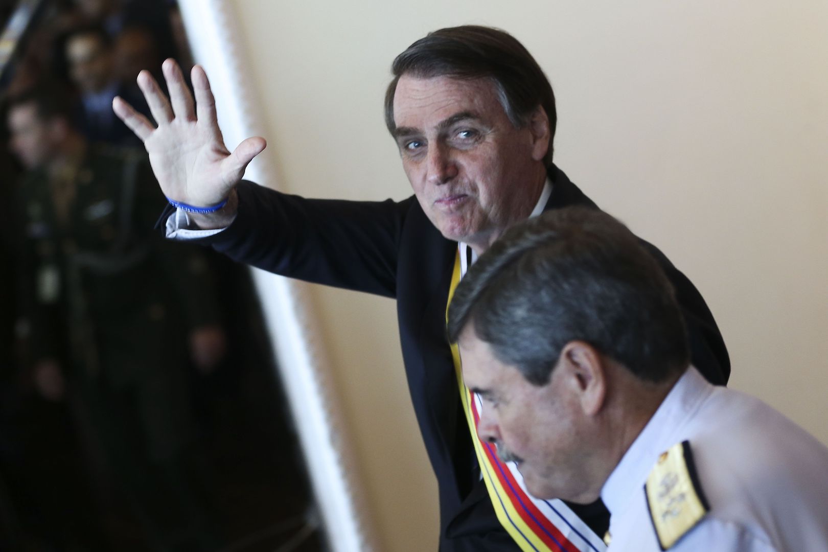 Brazil,President Jair Bolsonaro waves to reporters after ceremony in Brasilia,