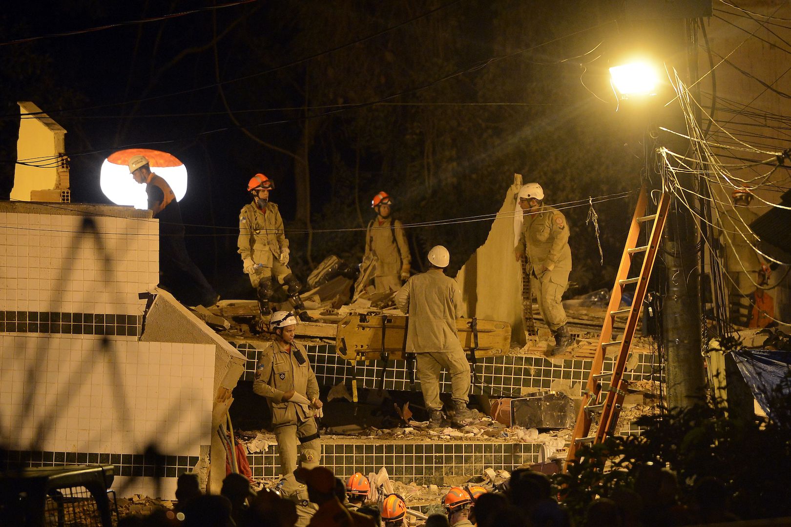 Brazil, Rio de Janeiro,Firefighters work through a second night on Saturday, looking for survivors of Friday's building collapse in Muzema.