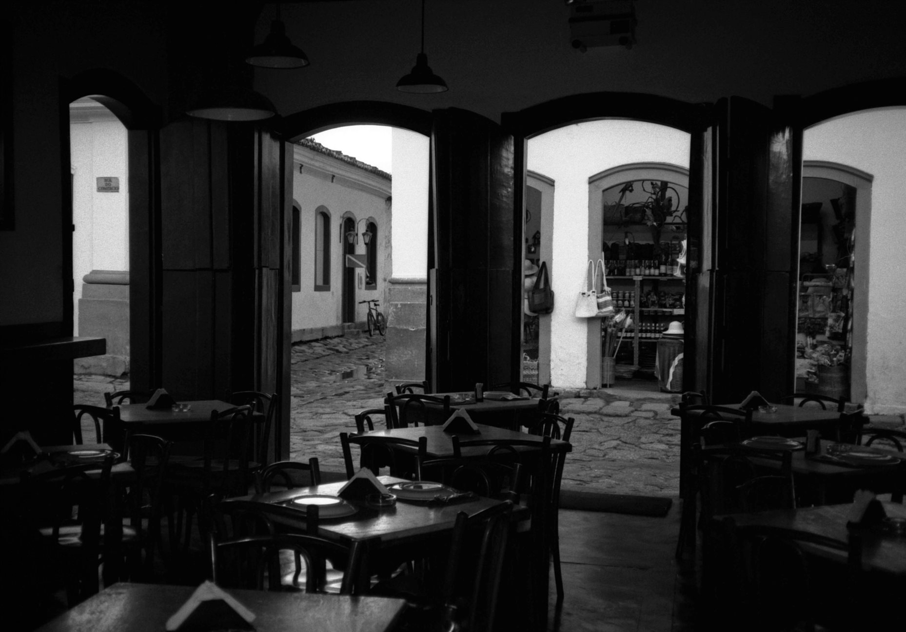 View characteristic colonial buildings & streetscape from inside cafeteria Paraty Rio de Janeiro Brazil Brasil South Latin Ameri