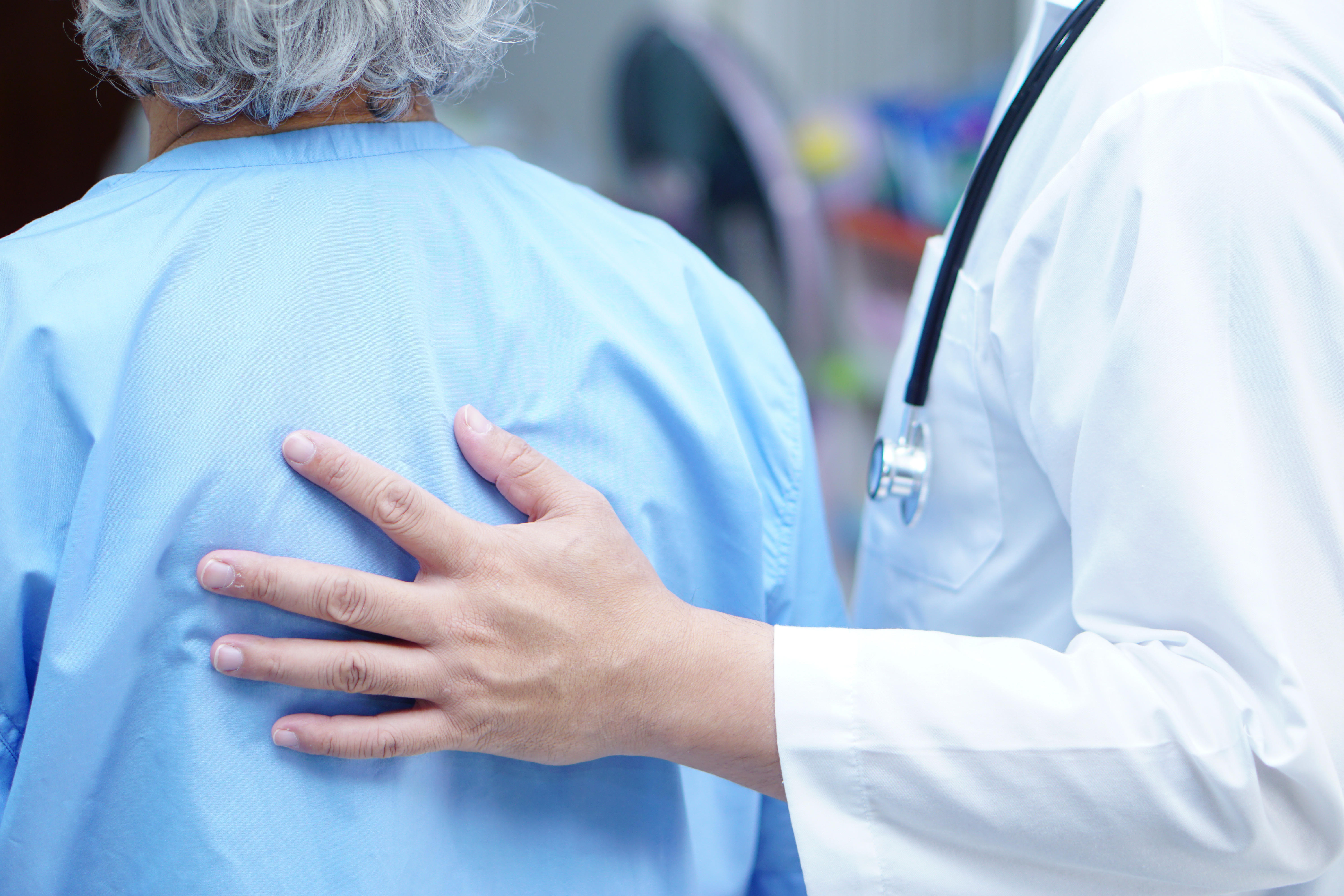 Doctor holding touching Asian senior or elderly old lady woman patient with love, care, helping, encourage and empathy at nursing hospital ward.