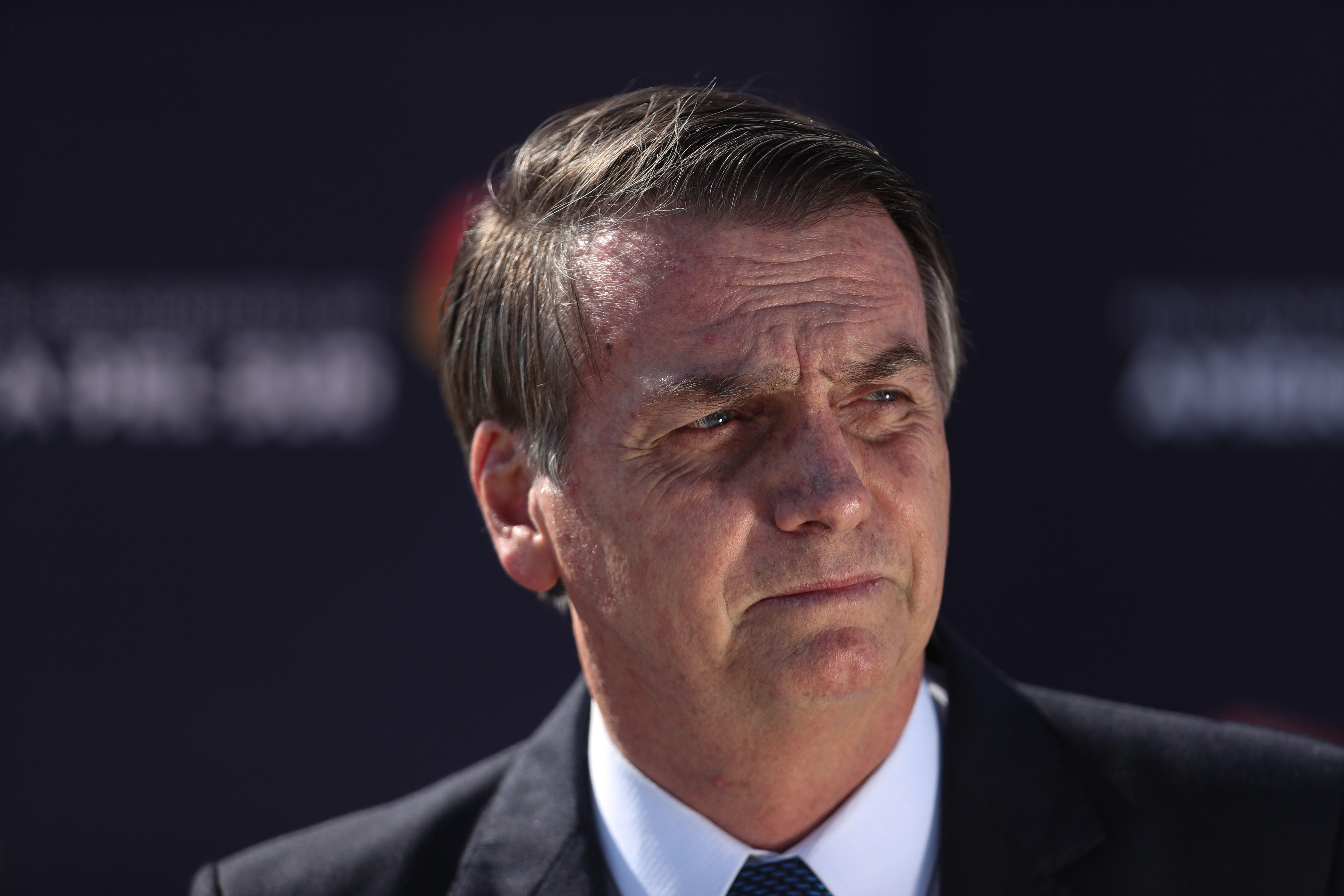 Brazil's President Jair Bolsonaro (C) arrives in Santiago, Chile, 21 March 2019, where he will take part in a meeting of several Latin American leaders to deliver the foundational act of the new regional integration project Prosur. EFE/ Alberto Valdes