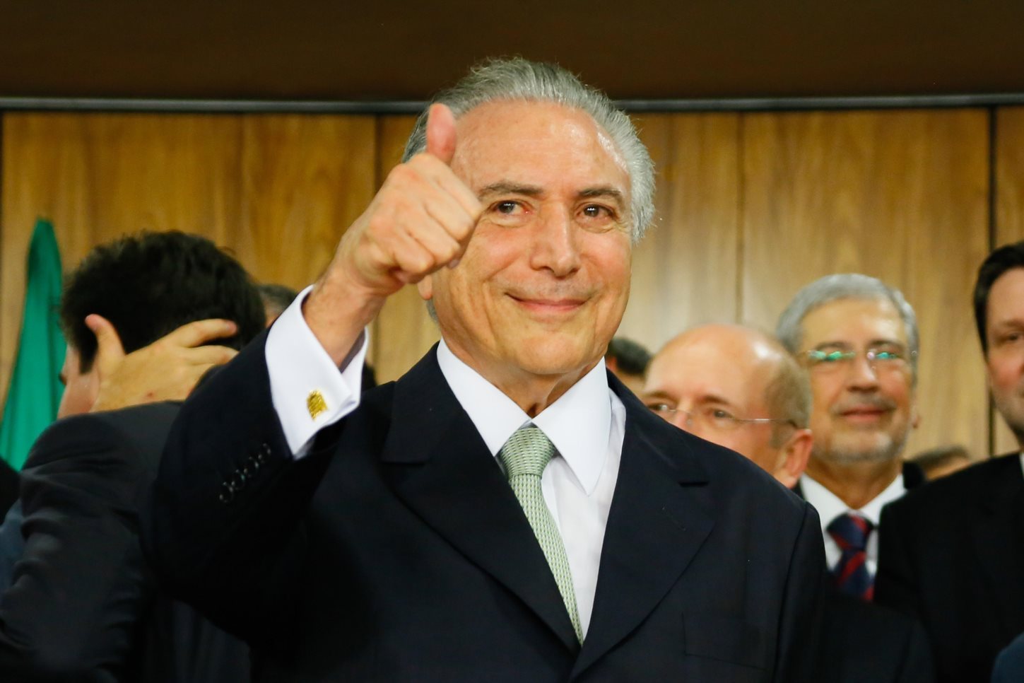 Acting Brazilian President Michel Temer gives a thumbs up after taking office following the suspension of elected President Dilma Rousseff at the Planalto Palace May 12, 2016 in Brasilia, Brazil. The Senate voted overwhelmingly to suspend Rousseff as the
