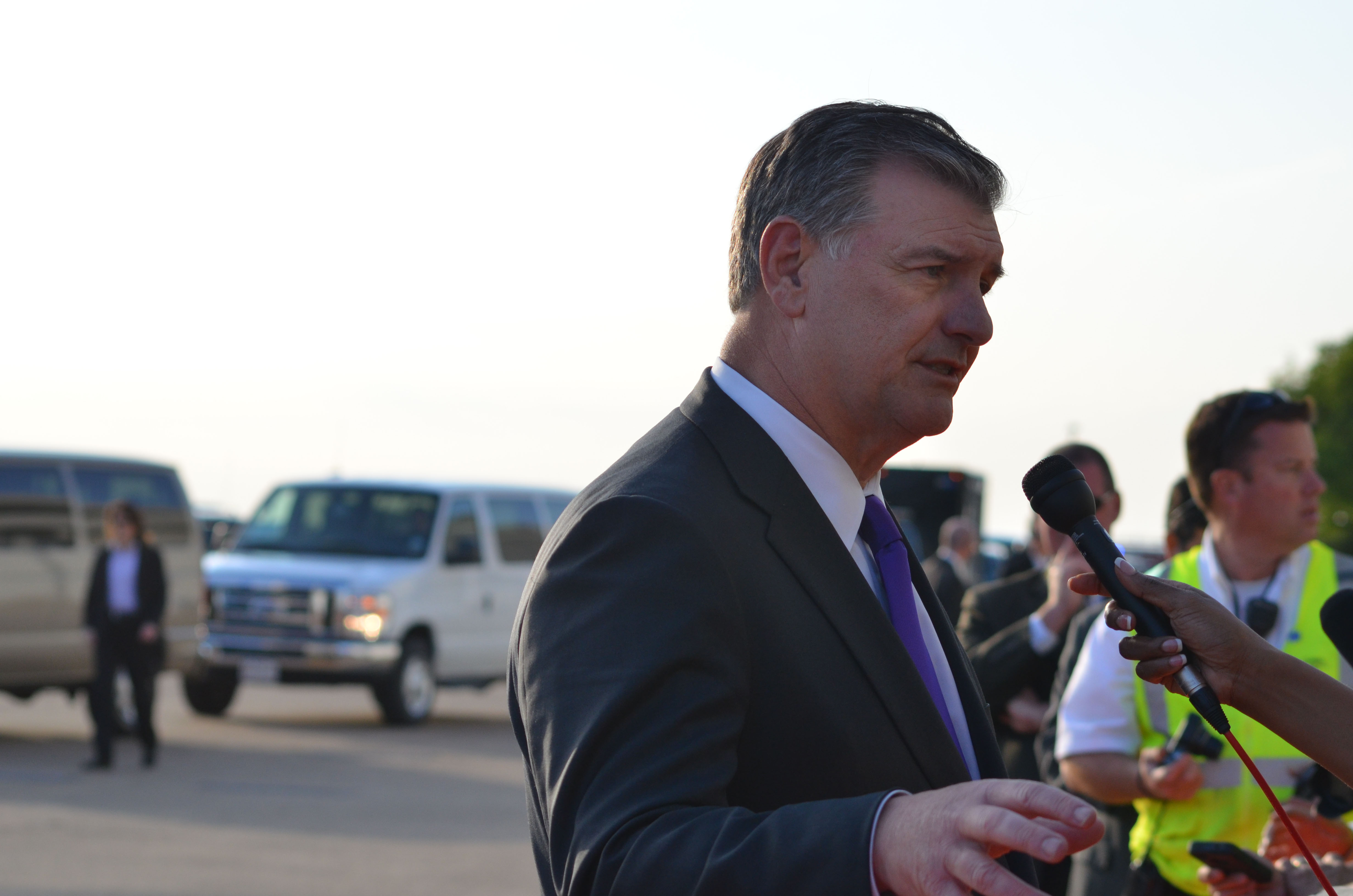 Dallas Mayor Mike Rawlings speaks to press at arrival ceremony for President Obama in Dallas, Texas.