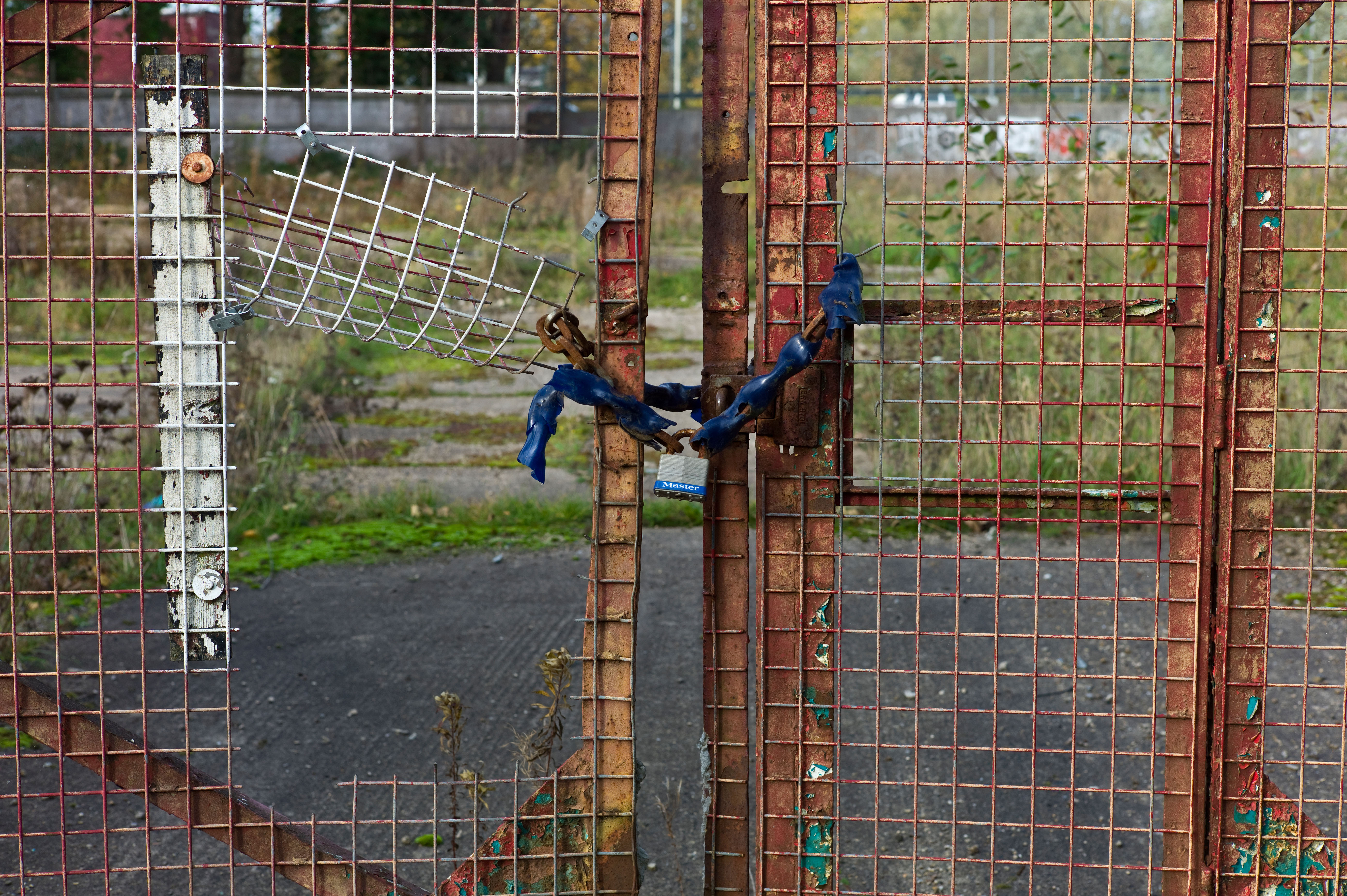 A chained up entrance gate to the wasteland site of a bankrupt business in the recession