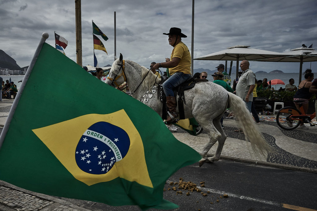 A demonstrator rides a horse on Copacabana beach during an act in support of Brazil's President Jair Bolsonaro (Photo: C.H. Gardiner)