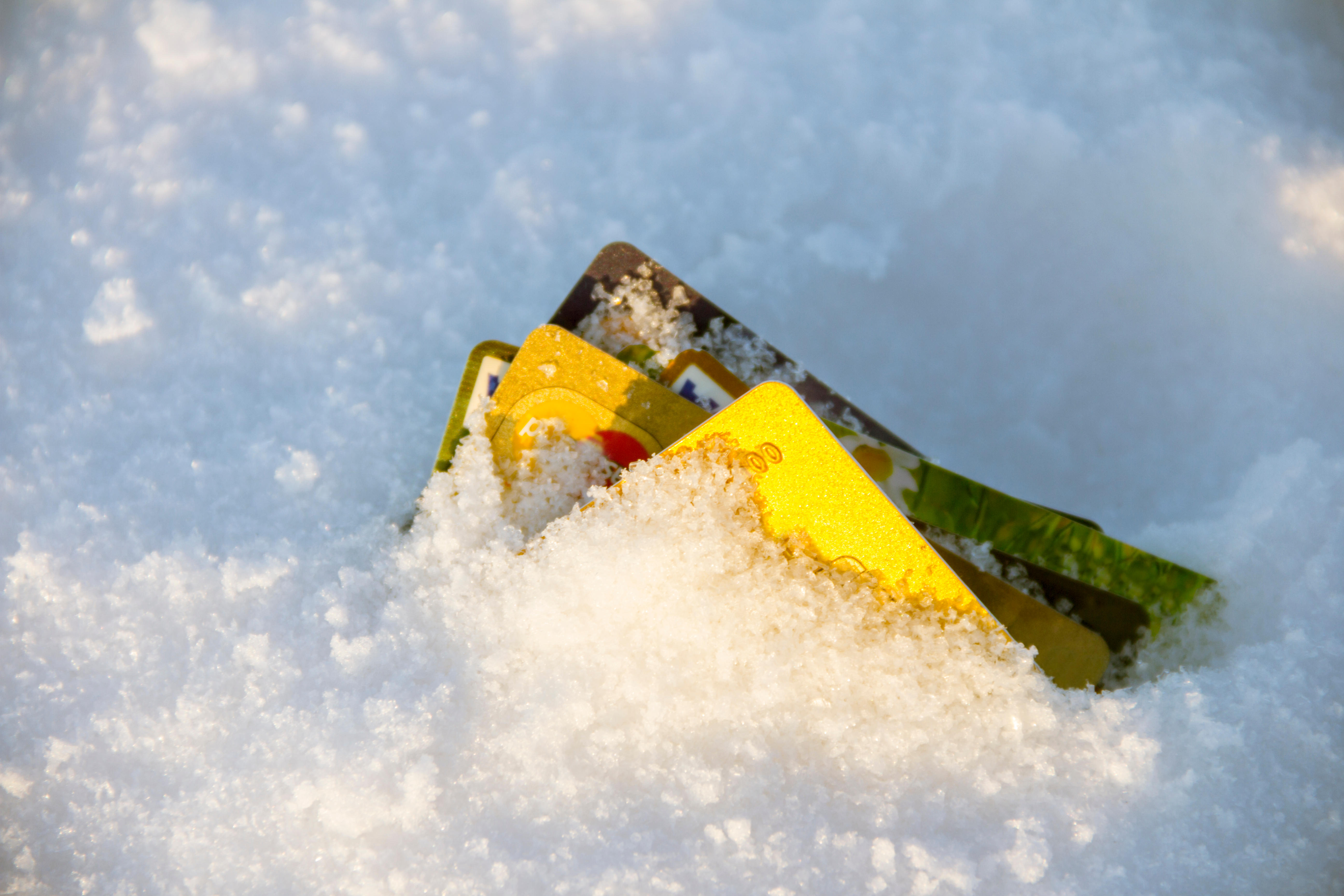 Frozen Bank Account Concept photo. Credit Cards buried in snow.