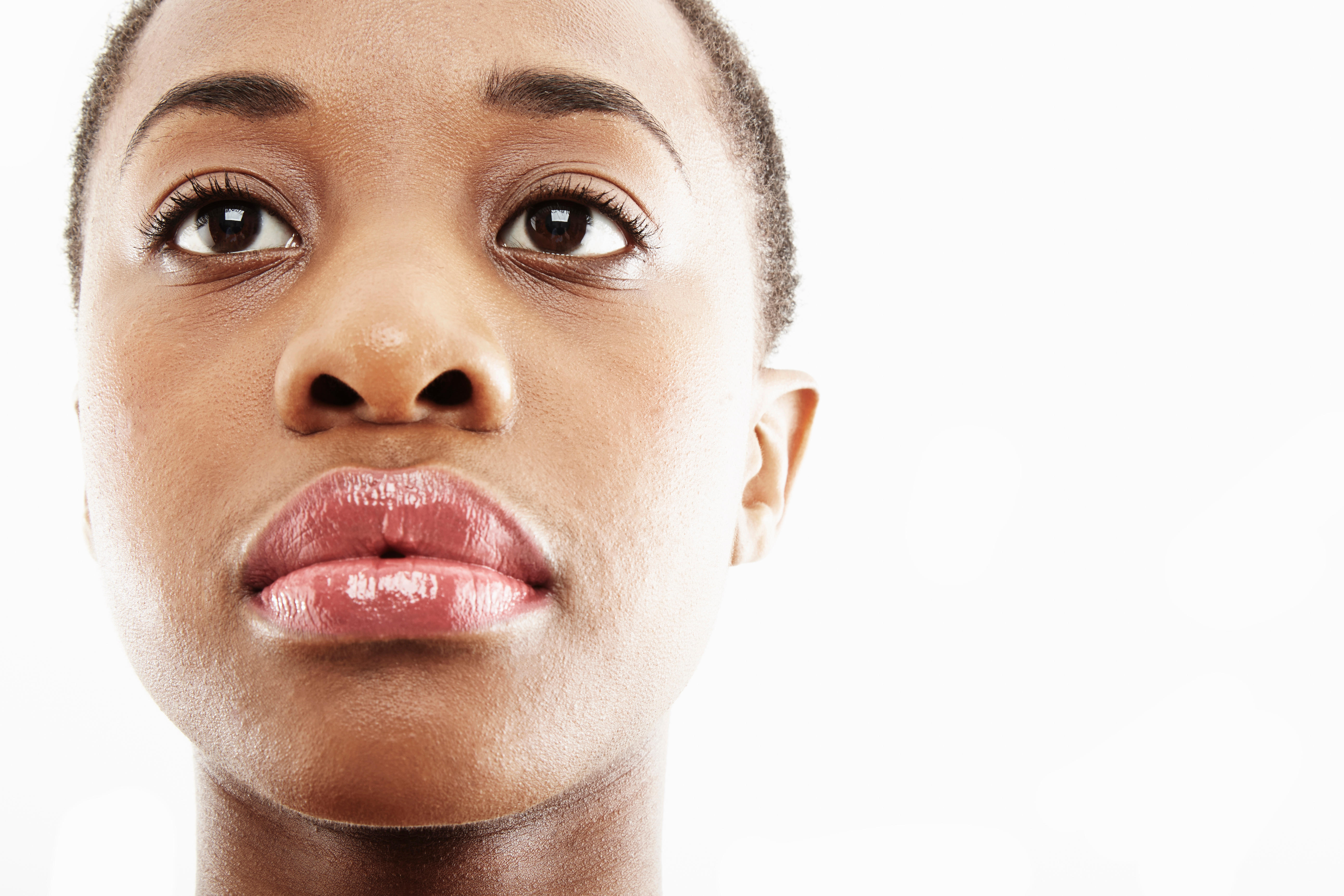 Close up studio portrait of sad young woman