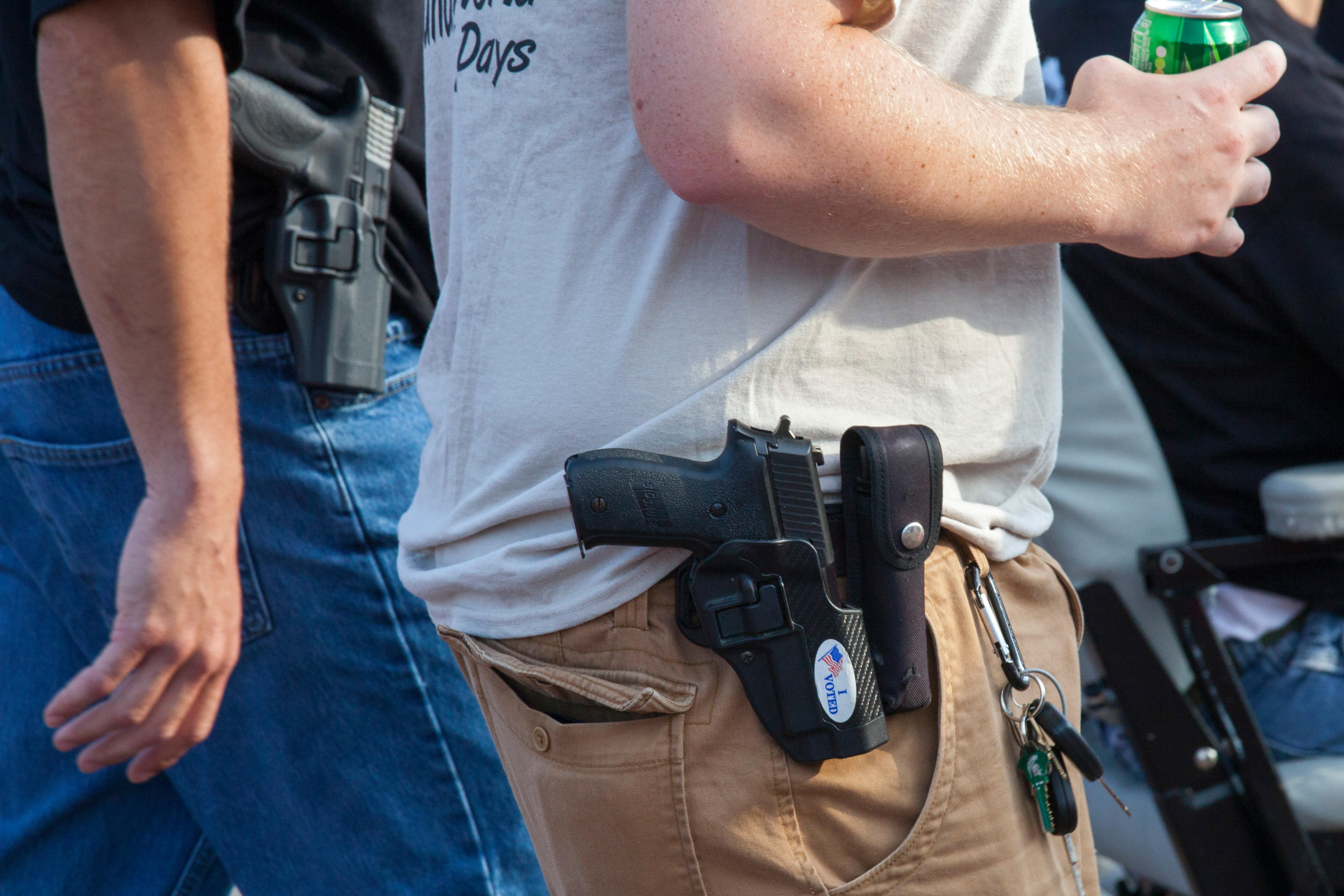 Detroit, Michigan - Members of the Ironworkers union openly carry hand guns during Detroit's Labor Day parade.