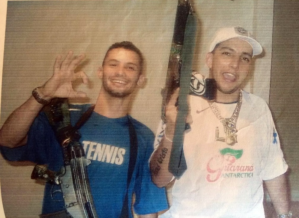 Fernando Gomes de Freitas, right, holds a firearm in a photo taken prior to his death (Photo: Social Media)