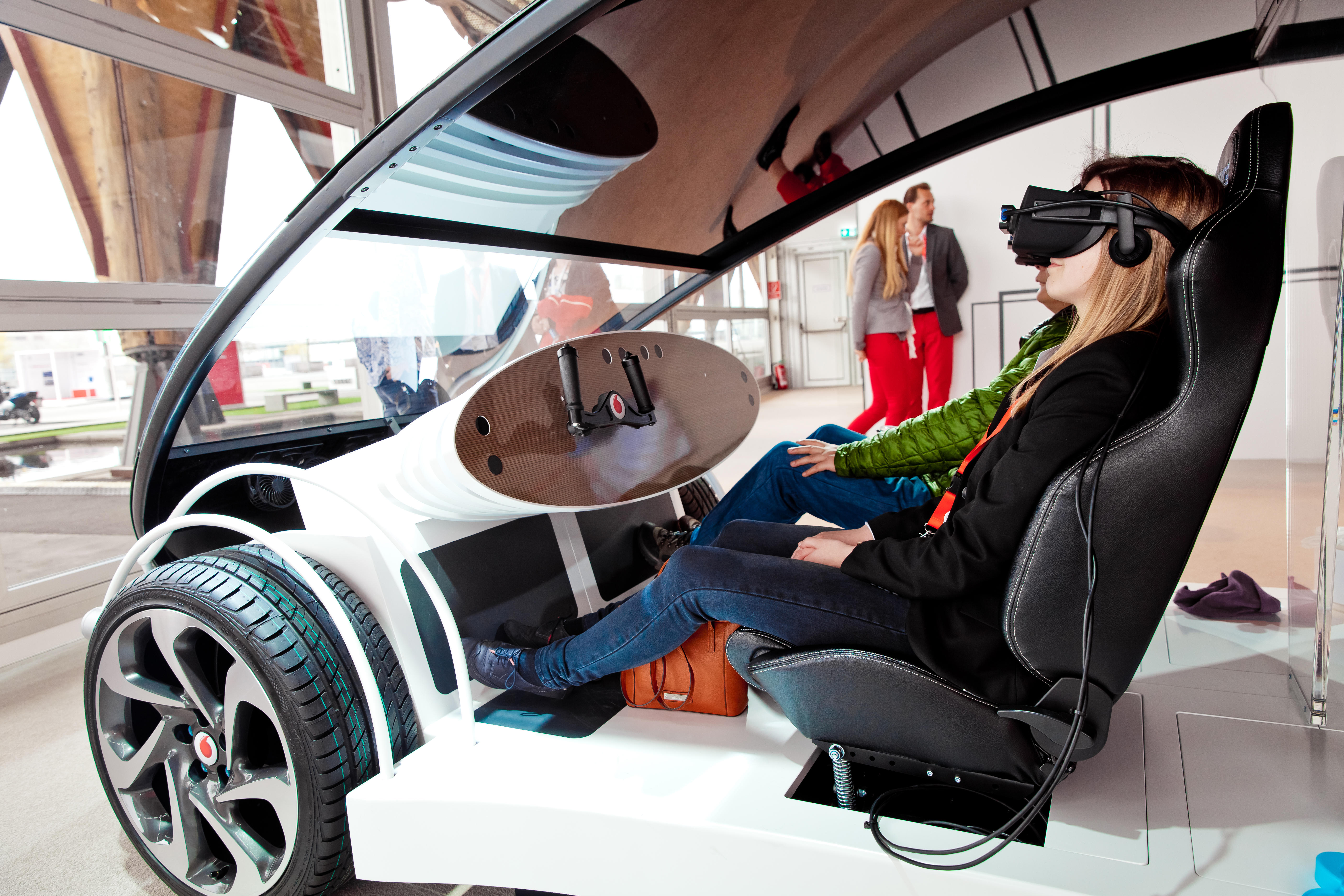 Girl in virtual glasses headset testing Vodafone 5G-based communications systems for vehicles on exhibition Cebit 2017 in Hannover Messe, Germany