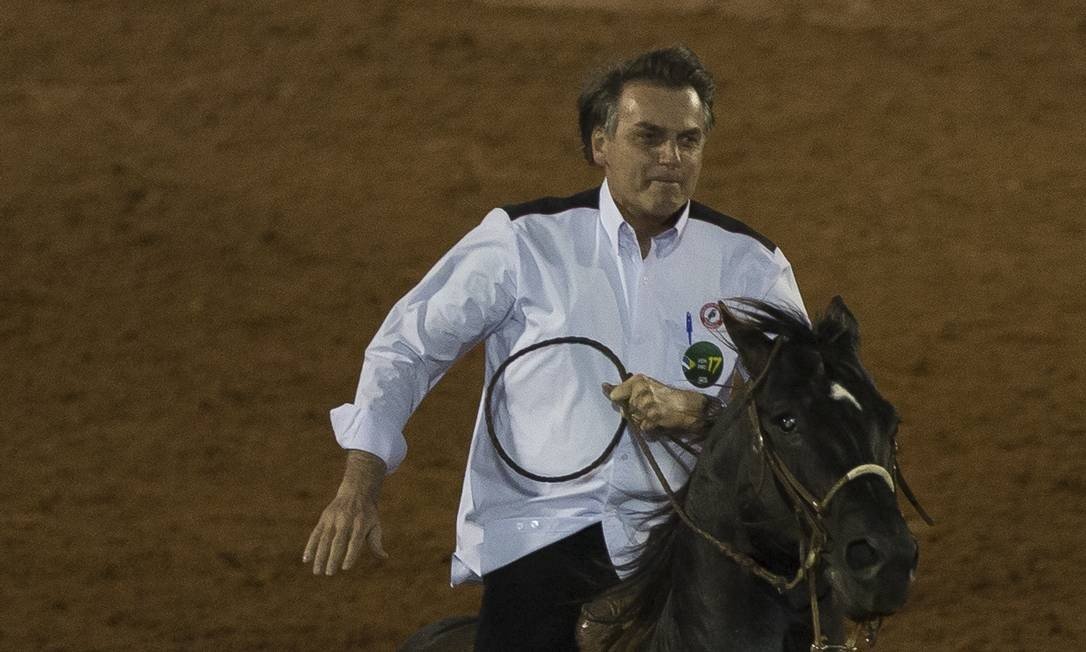 Brazilian President Jair Bolsonaro riding horseback at the Barretos Cowboy Festival.