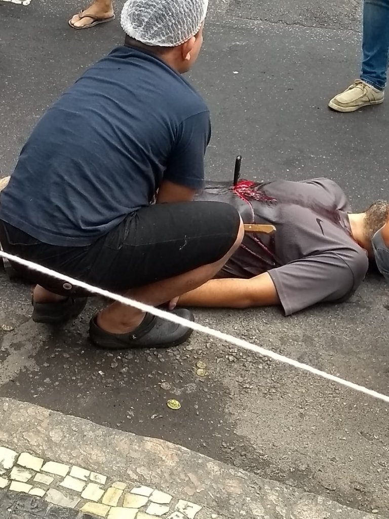 Edivaldo Ribeiro de Farias lays in the street after stabbing himself Thursday. (Photo: Social Media)