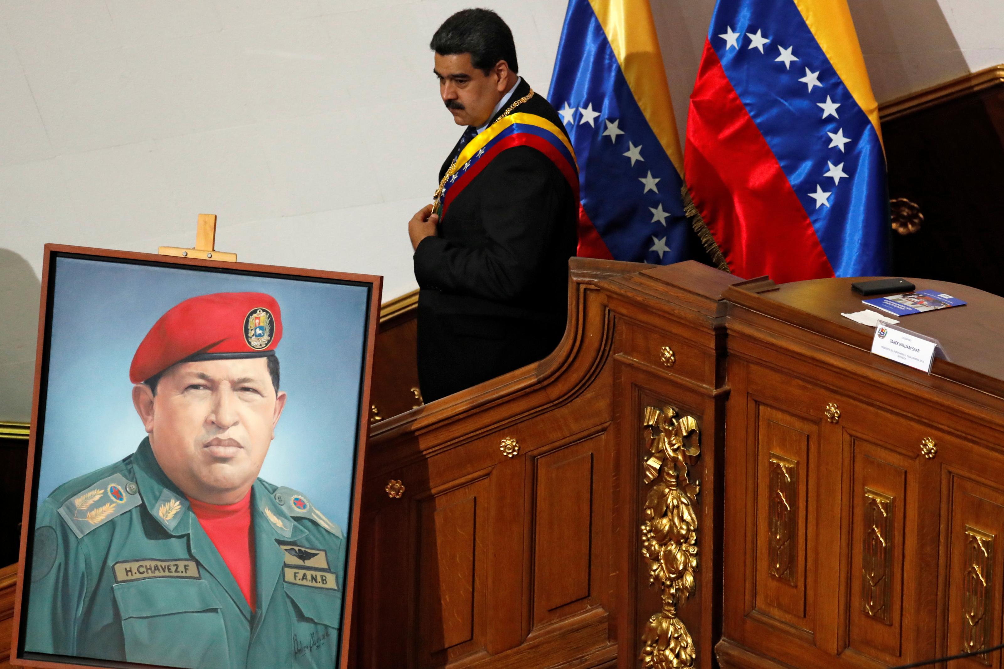 Venezuelan President Nicolás Maduro and the picture of former President Hugo Chávez.