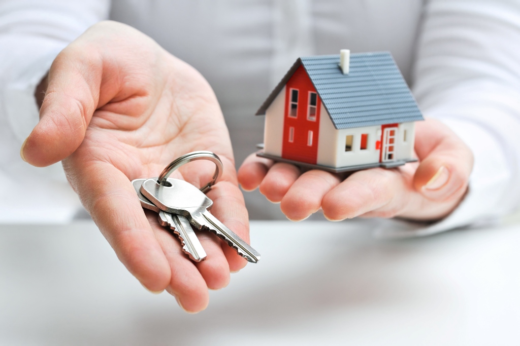 Real estate agent with house model and keys