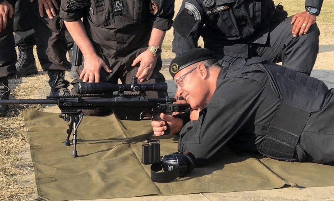 Governor-Wilson-Witzel-poses-for-a-photo-aiming-through-the-scope-of-a-sniper-rifle.-Photo-press-release