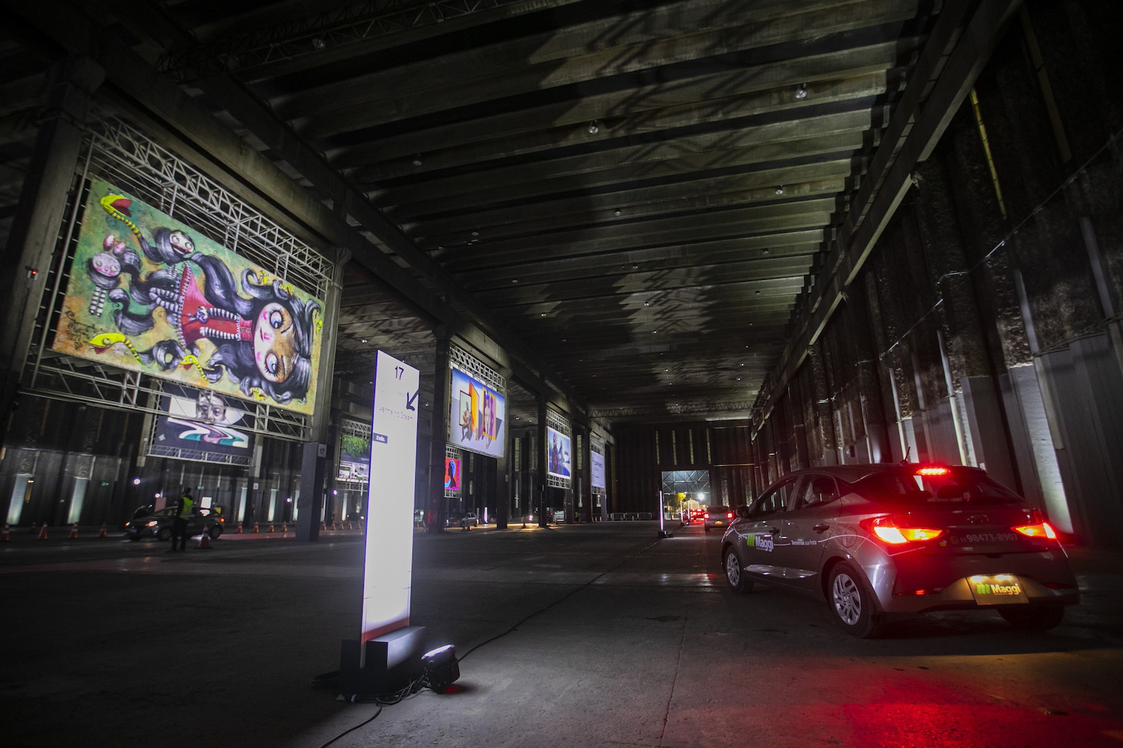 Brazil,São Paulo residents remain inside their automobiles while touring the art gallery.