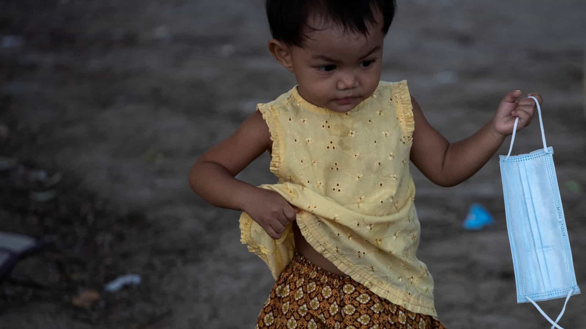 child holding mask
