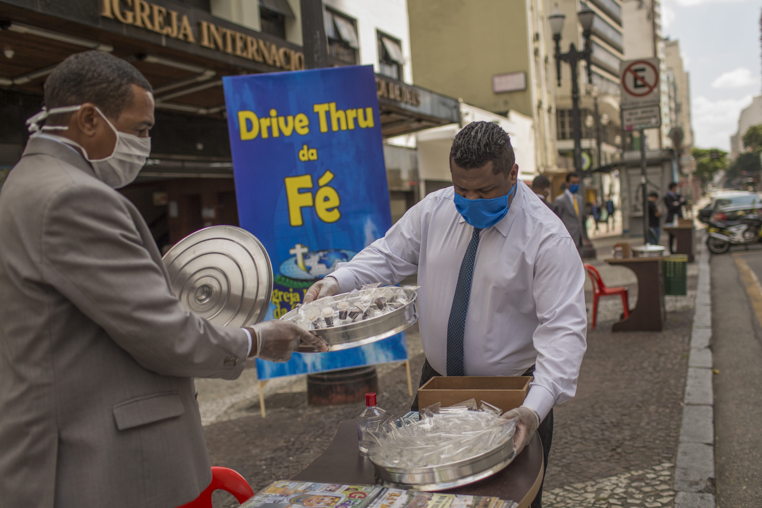 Pastors prepare for a drive-through faith service outside a church in São Paulo.