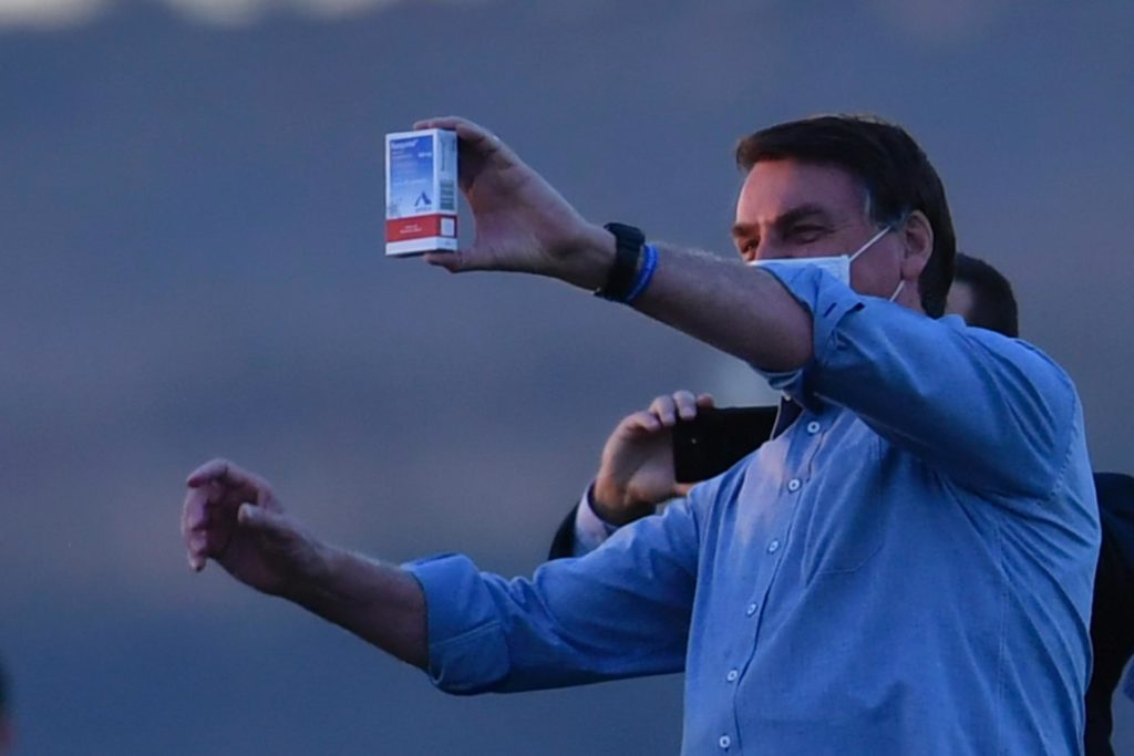 Brazilian President Jair Bolsonaro holding a package of chloroquine.