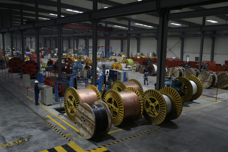 A worker monitors automatic copper wire unit at the Fast Cables plant in Lahore