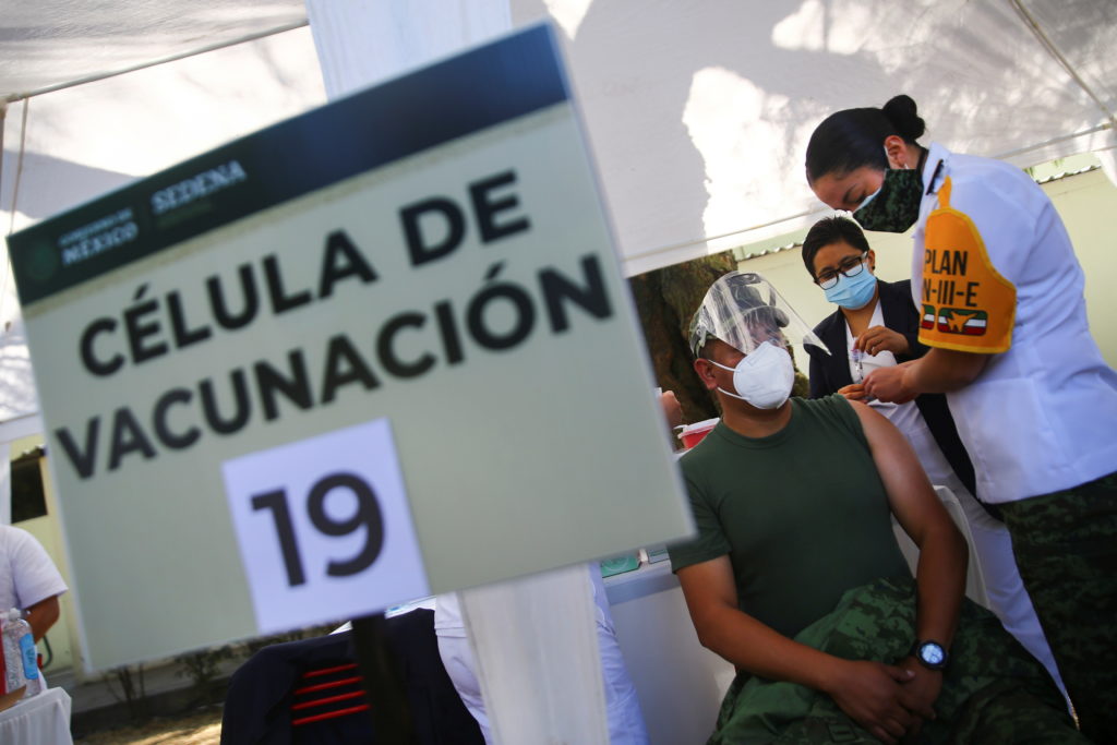 Medical staff members receive the first injection with a dose of the Pfizer/BioNTech COVID-19 vaccine in Mexico City