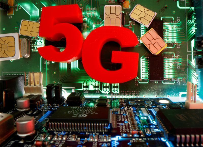 SIM cards and 3d printed objects representing 5G are put on a motherboard in this picture illustration