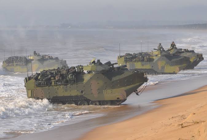 Locals shocked and surprised to see tanks emerging from waters on beach near Rio de Janeiro