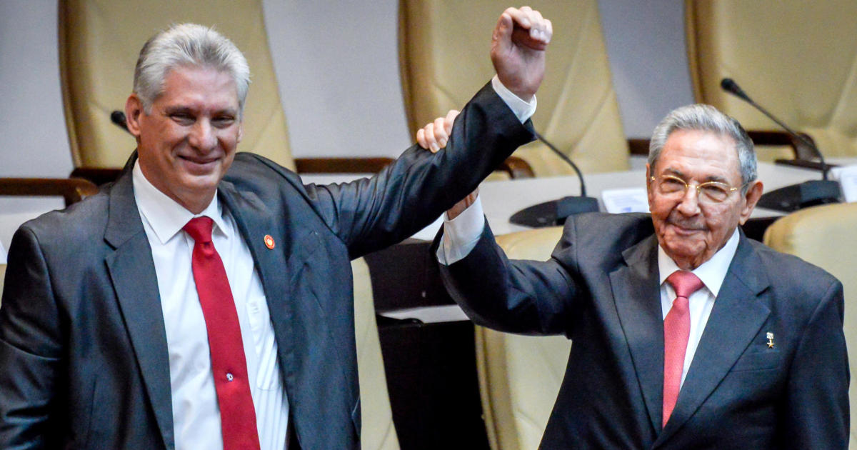 Newly elected Cuban President Miguel Diaz-Canel reacts as former Cuban President Raul Castro raises his hand during the National Assembly in Havana