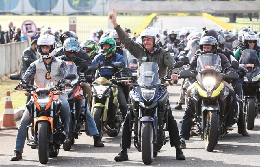 Brazil's Bolsonaro leads a motorcycle caravan in Rio de Janeiro and bathes in the crowd with his fans