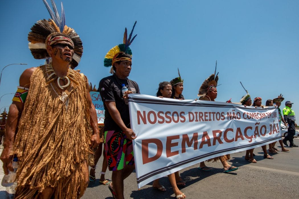 Indigenous people protesting: "Our rights didn't begin in 1988. Demarcation now!"