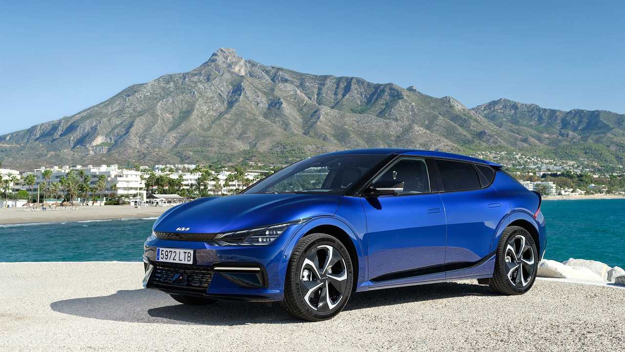 A blue Kia EV6 electric car parked on a seafront