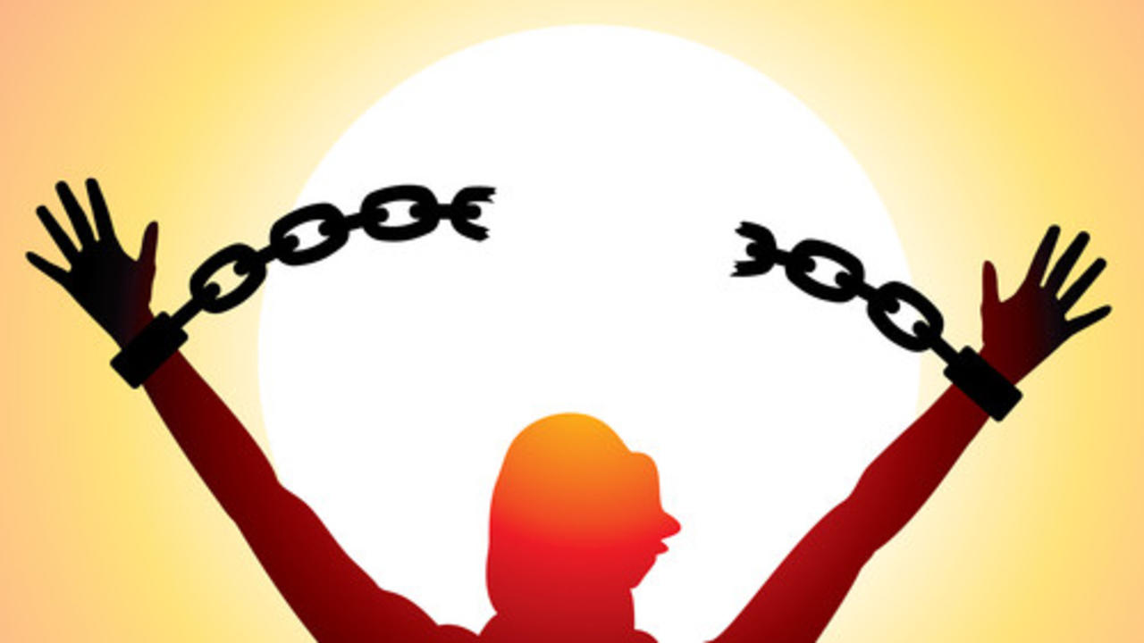 girl with raised hands and broken chains