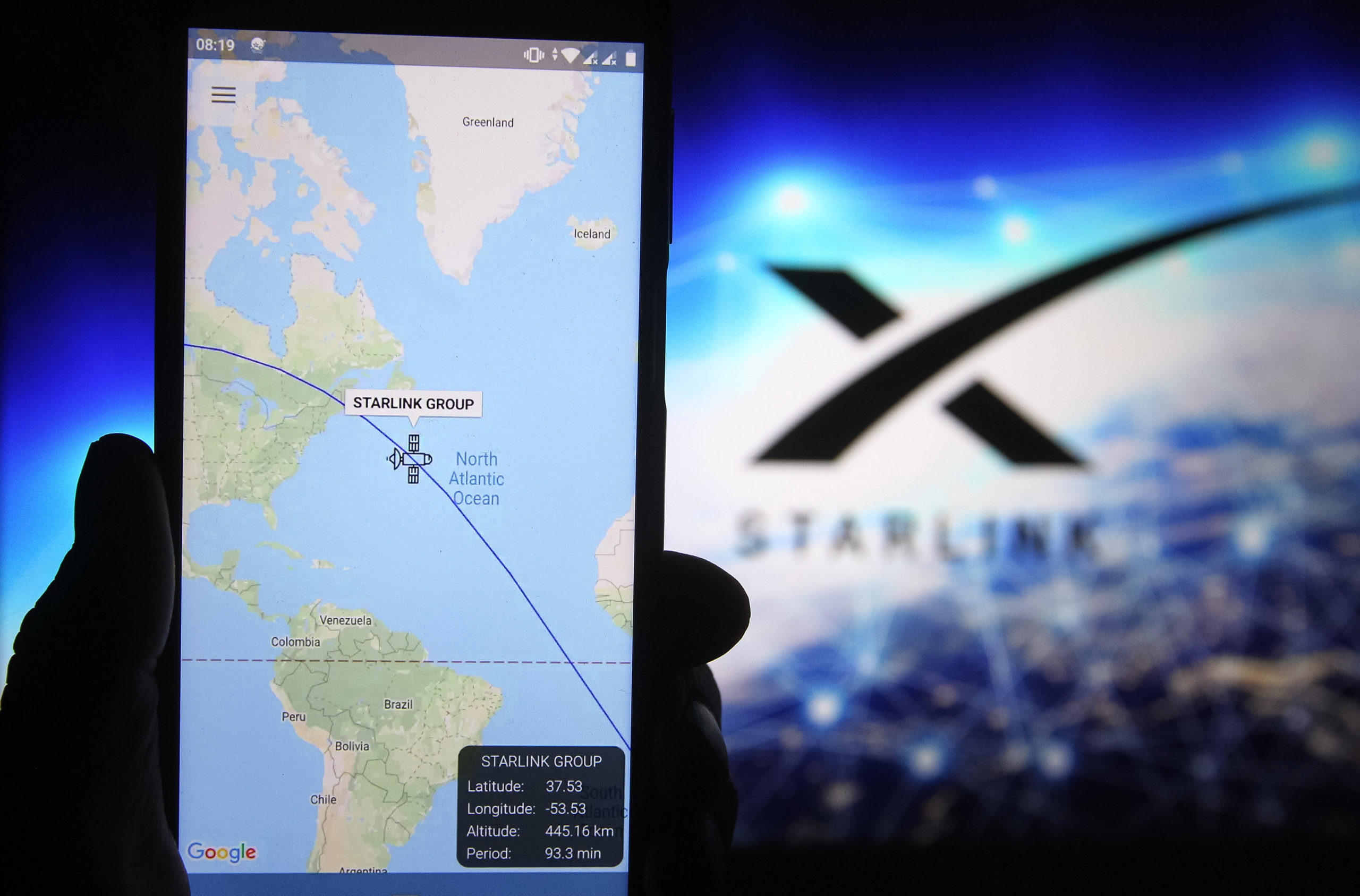 A satellite tracker image is seen displayed on a smartphone