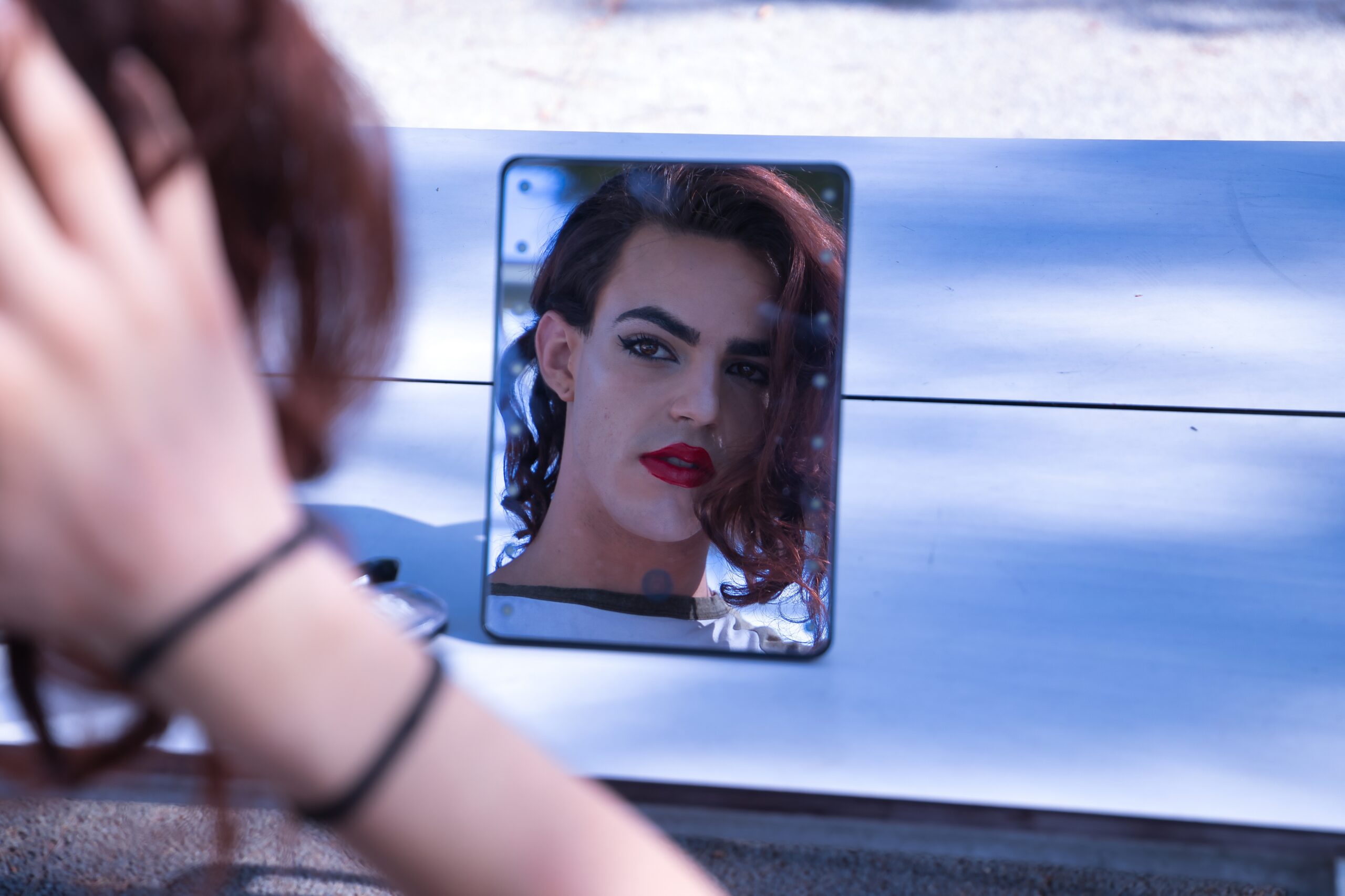 Young,Adult,Hispanic,Transsexual,Girl,Looking,In,A,Mirror,As
