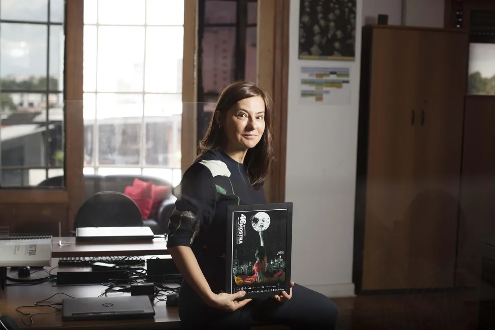 Renata de Almeida with the poster for this year's festival.