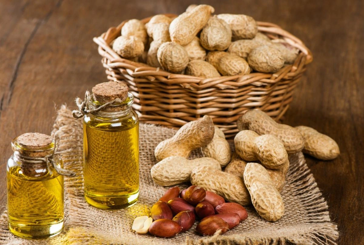 Bottles of Senegal peanut oil with peanuts, as peanut oil exports rise.