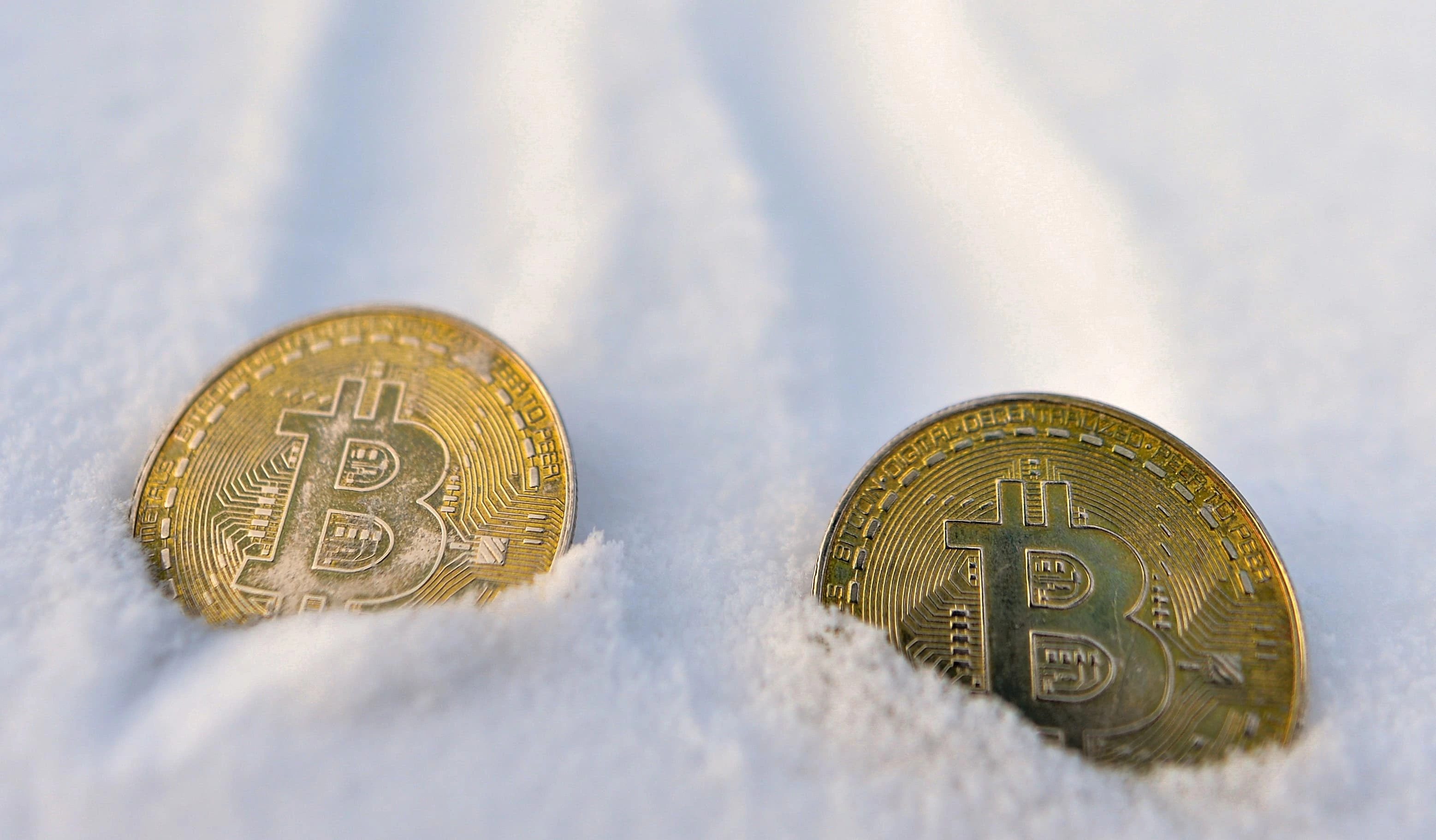 A Bitcoin coin as the Fed's higher-rates signal lifts the dollar and pulls crypto lower