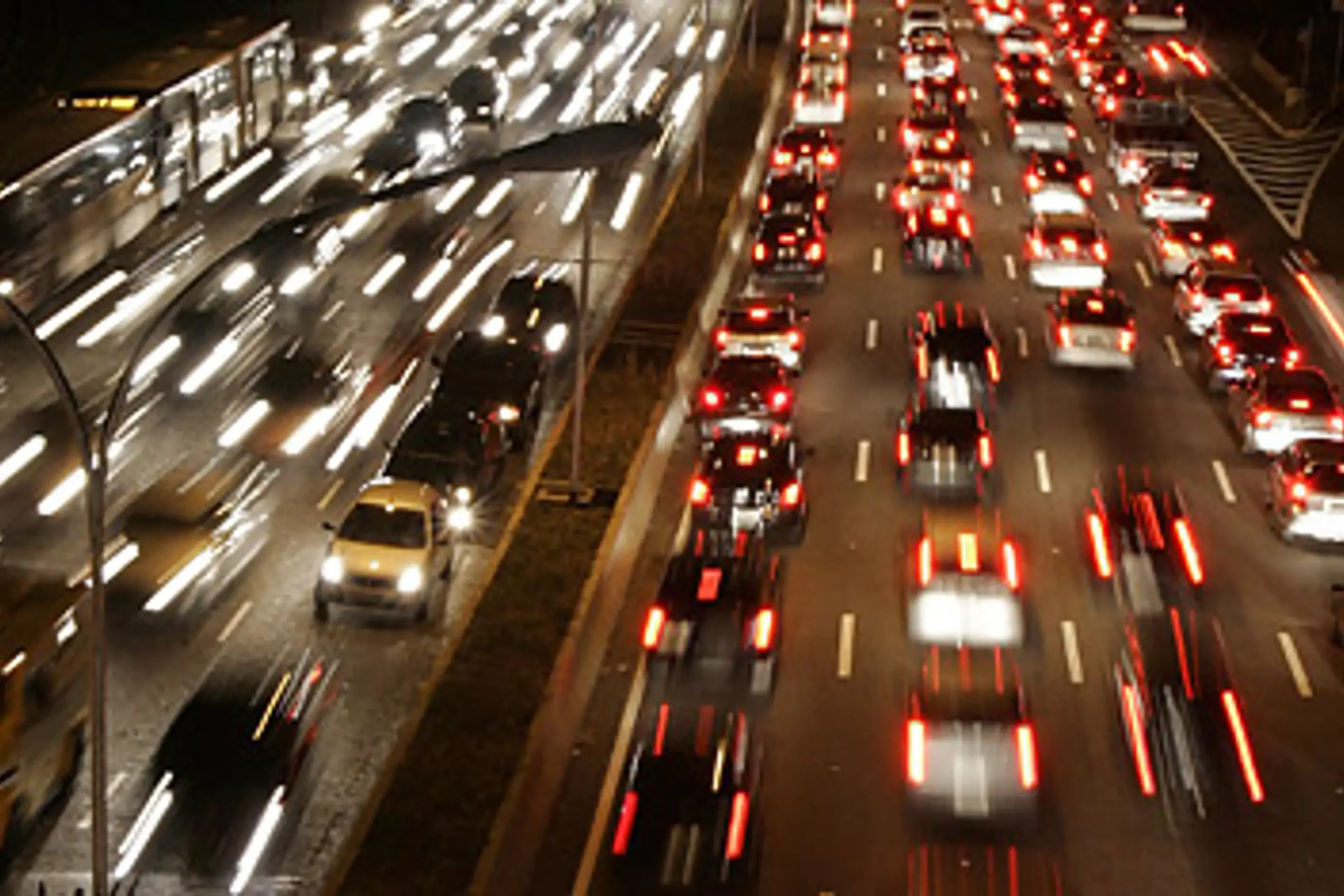 Busy highway traffic at night representing driving in Mexico