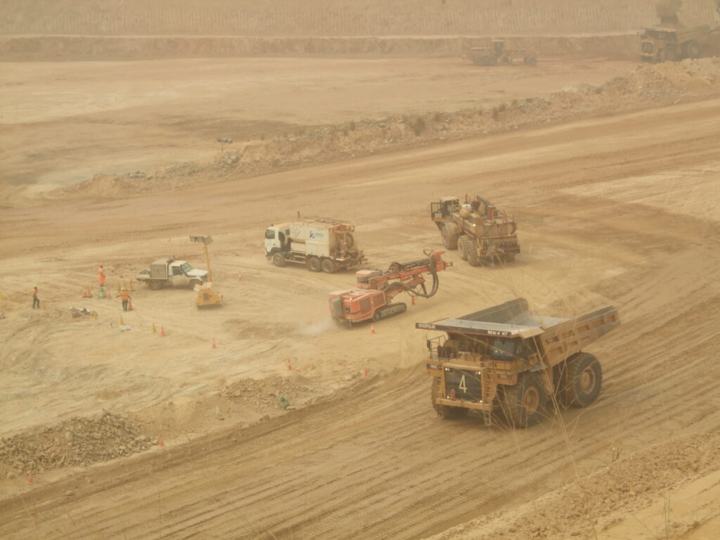 Open-pit mine with heavy machinery and workers