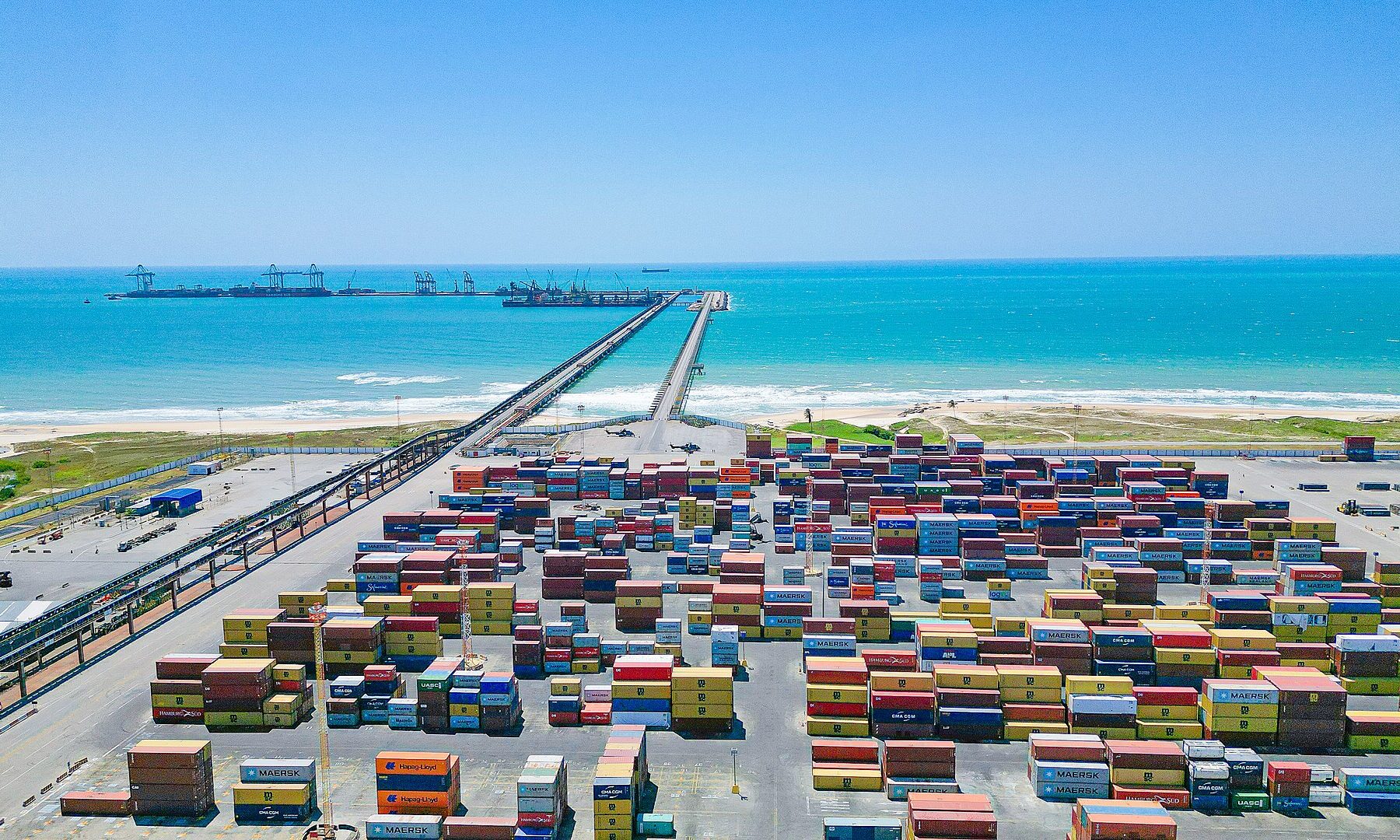 Aerial view of the Port of Pecém in Ceará, Brazil, with container stacks and the offshore pier