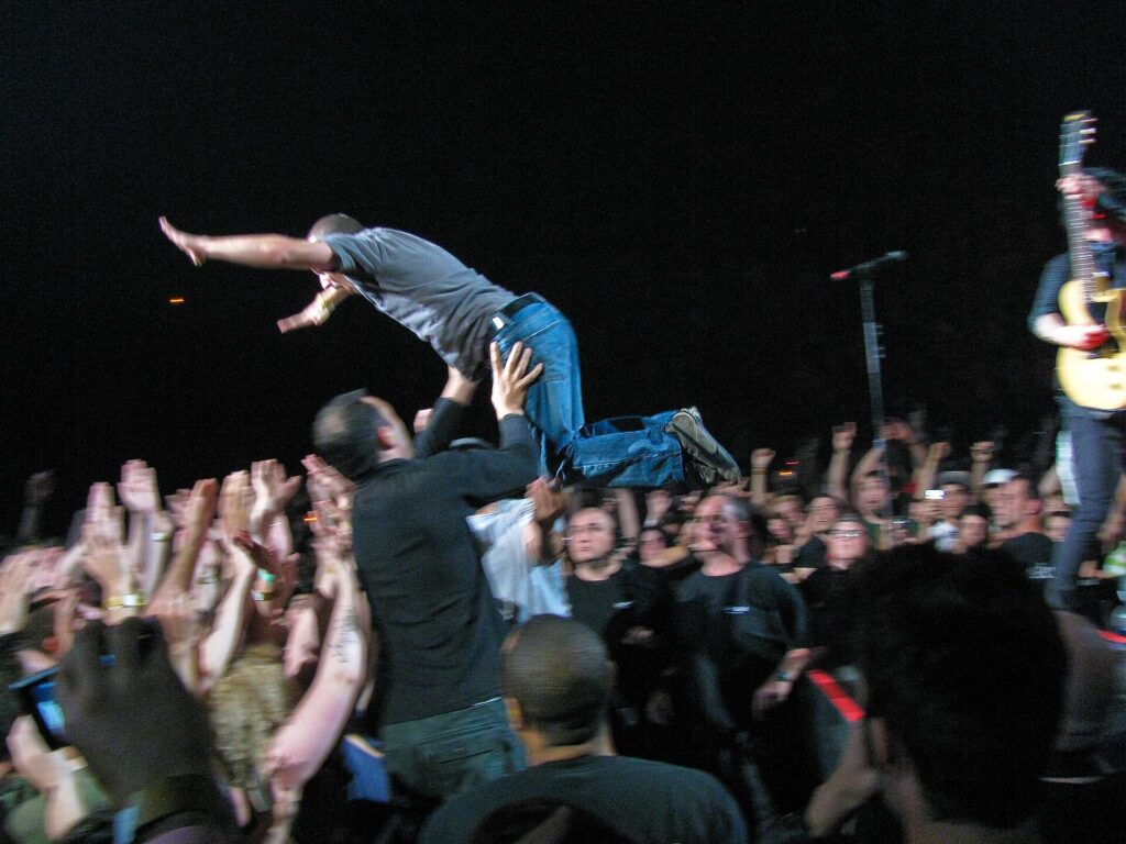 A concert crowd in front of a lit stage