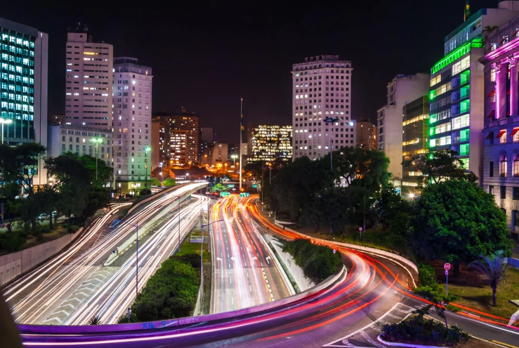 Cityscape at night with light trails from traffic