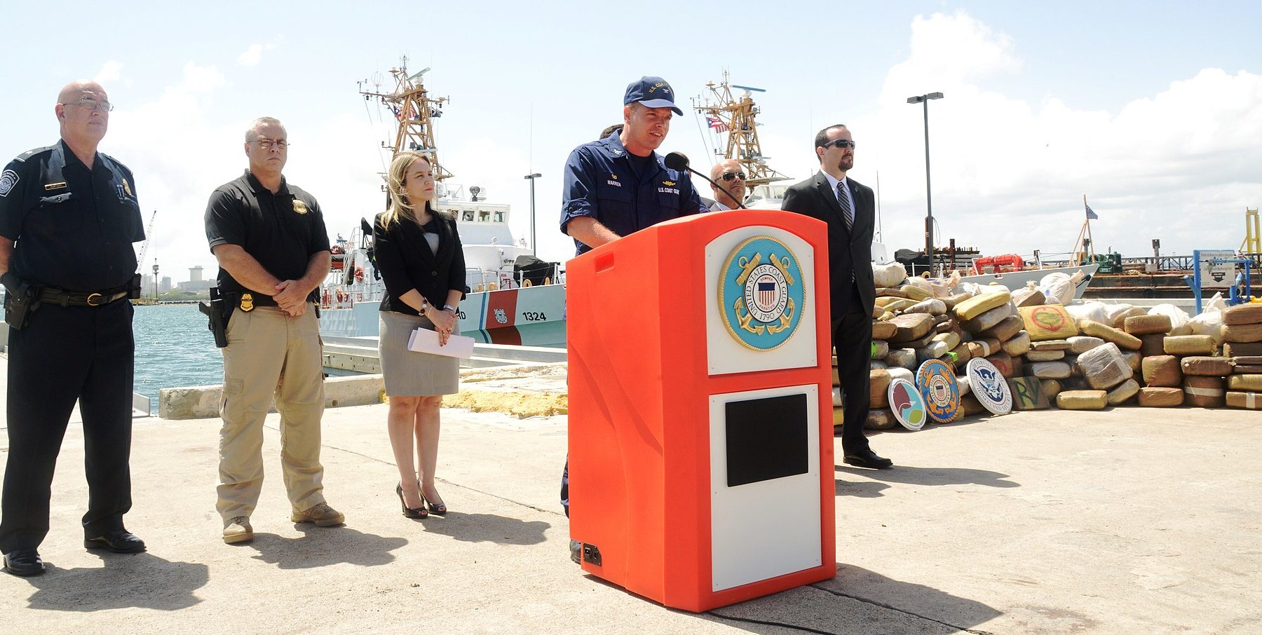 A US Coast Guard vessel interdicting a suspected drug-smuggling boat in the Caribbean Sea, representing the new security perimeter drawing Latin America into global conflict risk.